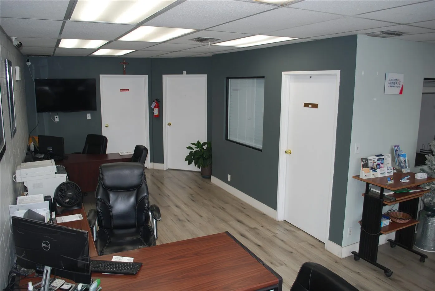 Inside the Original Insurance office, with teal walls and wood floors